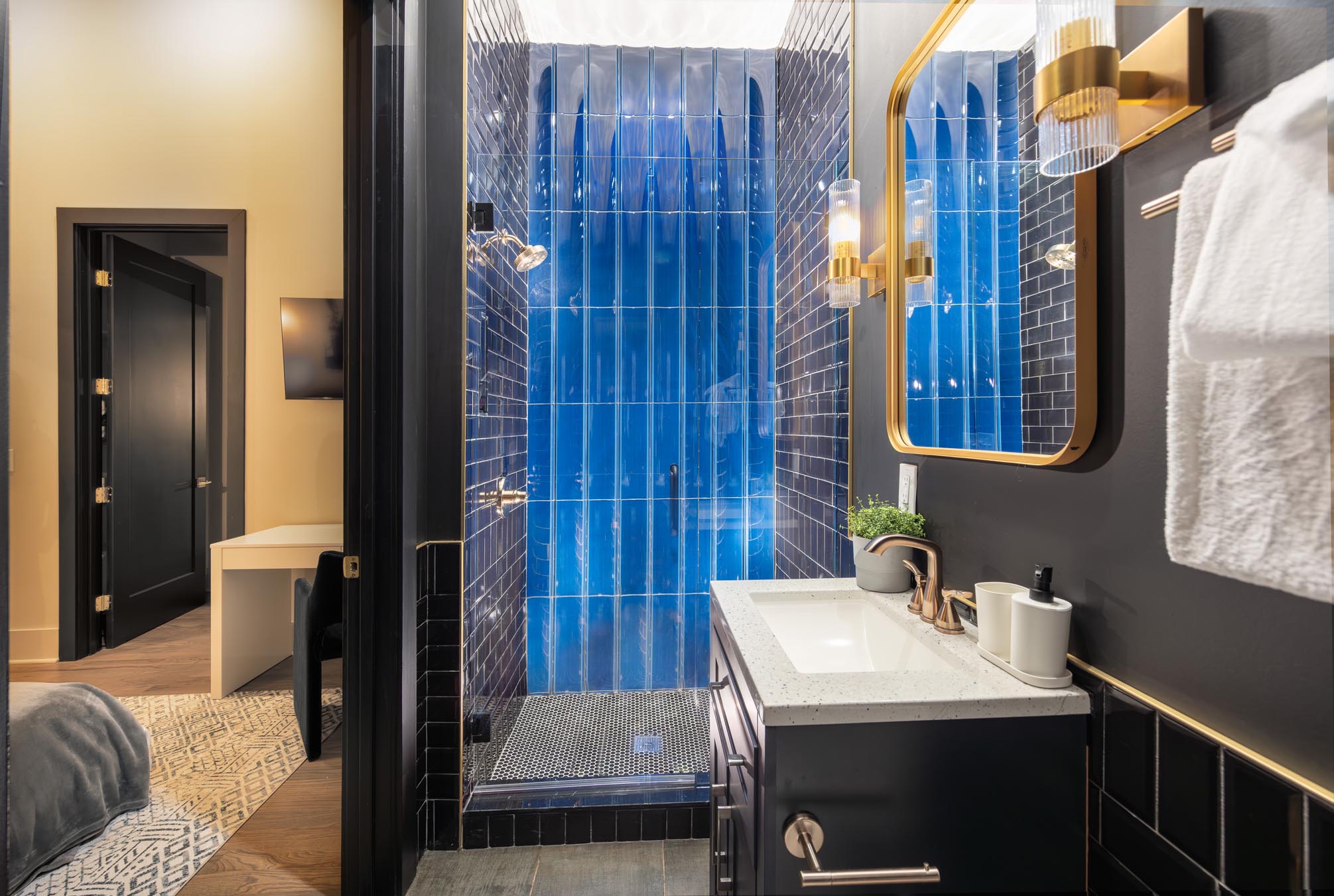 bathroom with blue tile in shower